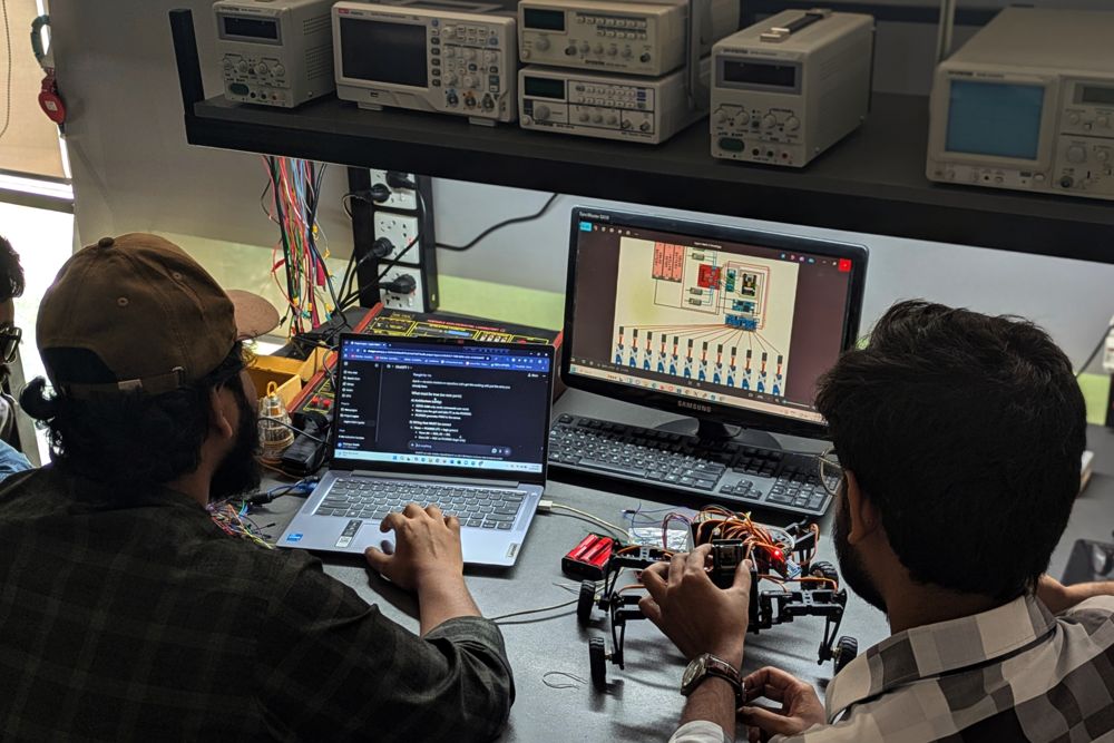 Students testing a controller on an electronics bench at UIU