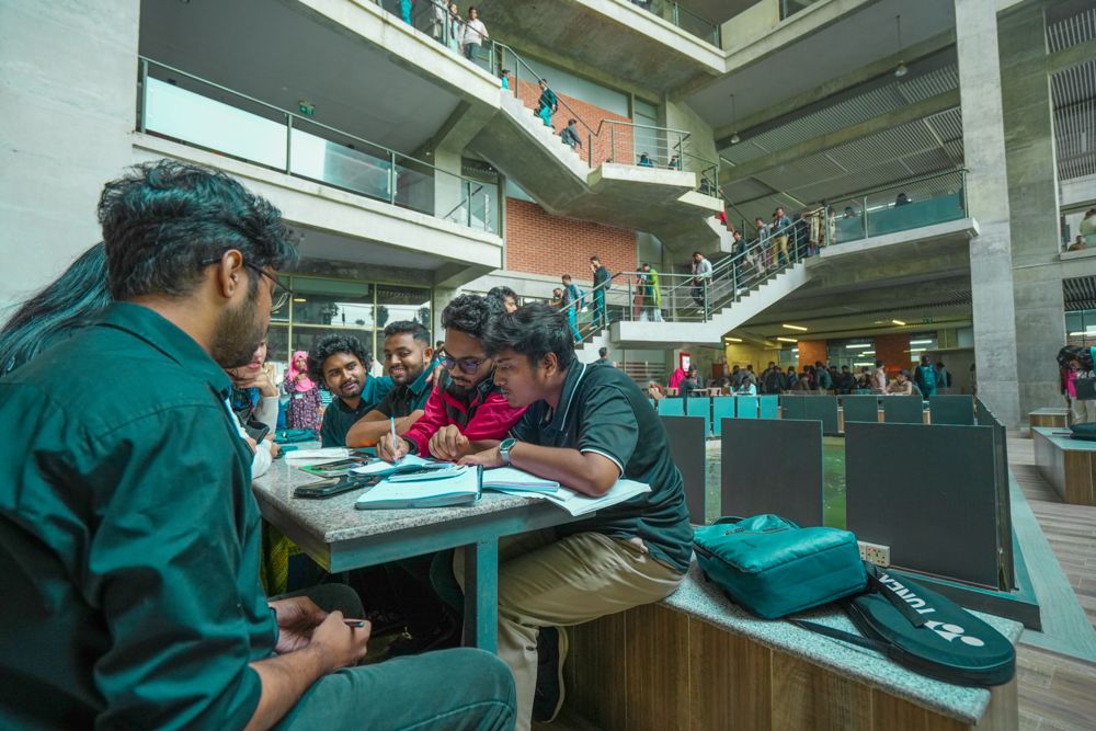 Students working together in the atrium